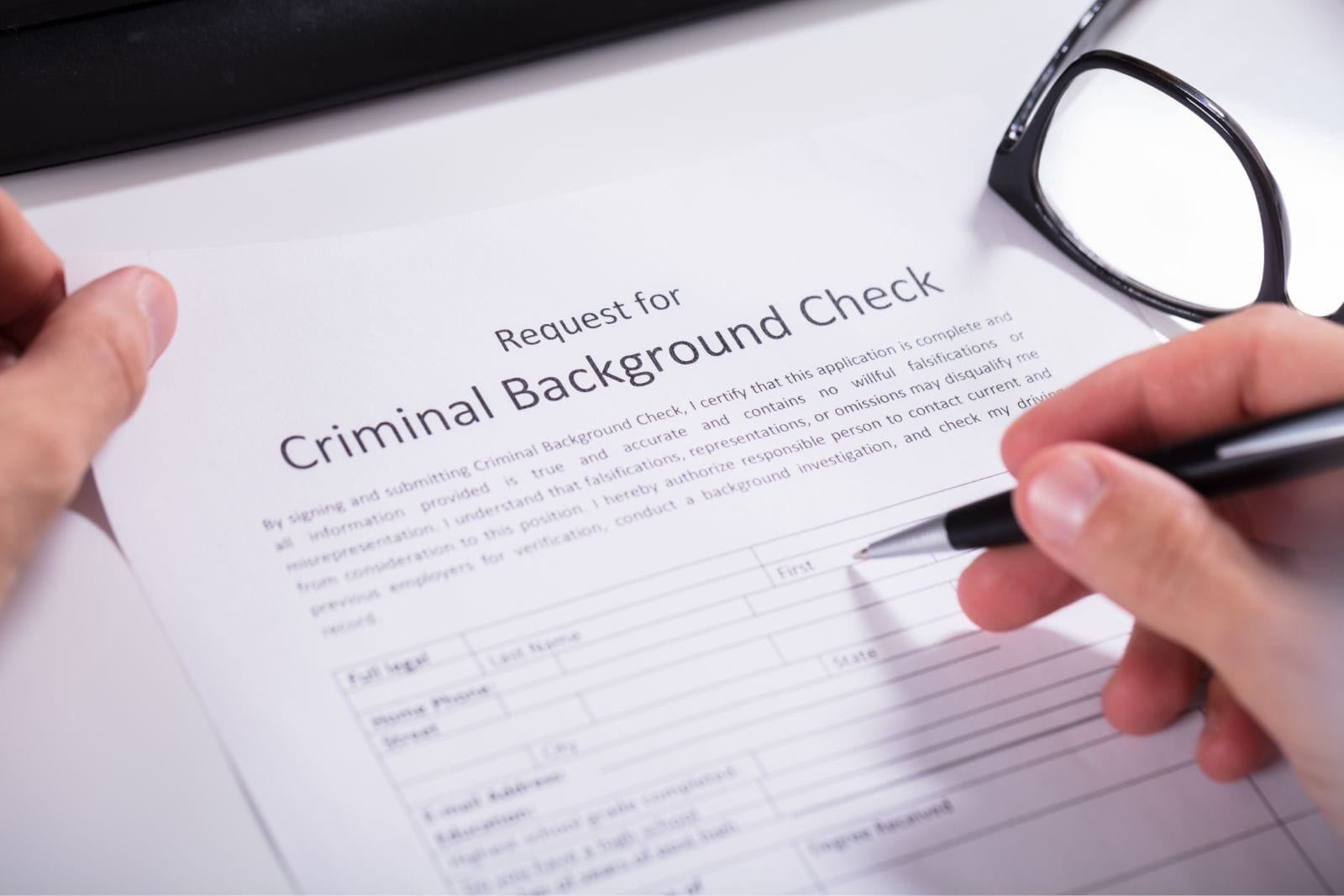 person filling out background check form